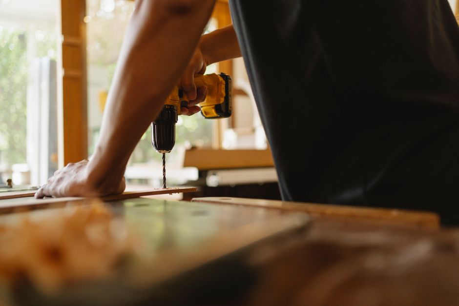 Professional carpenter carefully installing a wooden door